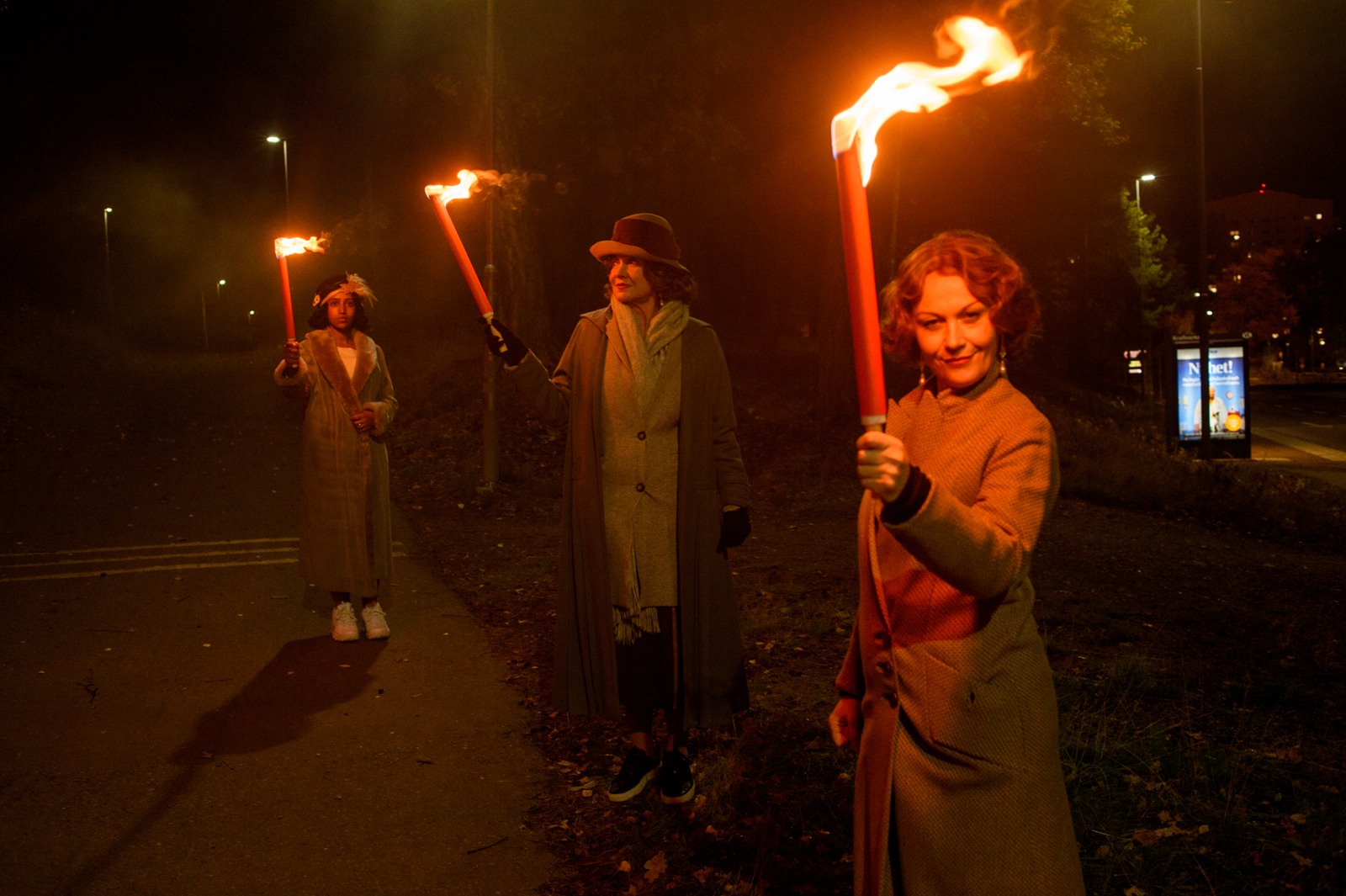Three live characters lead the way through a torchlit world