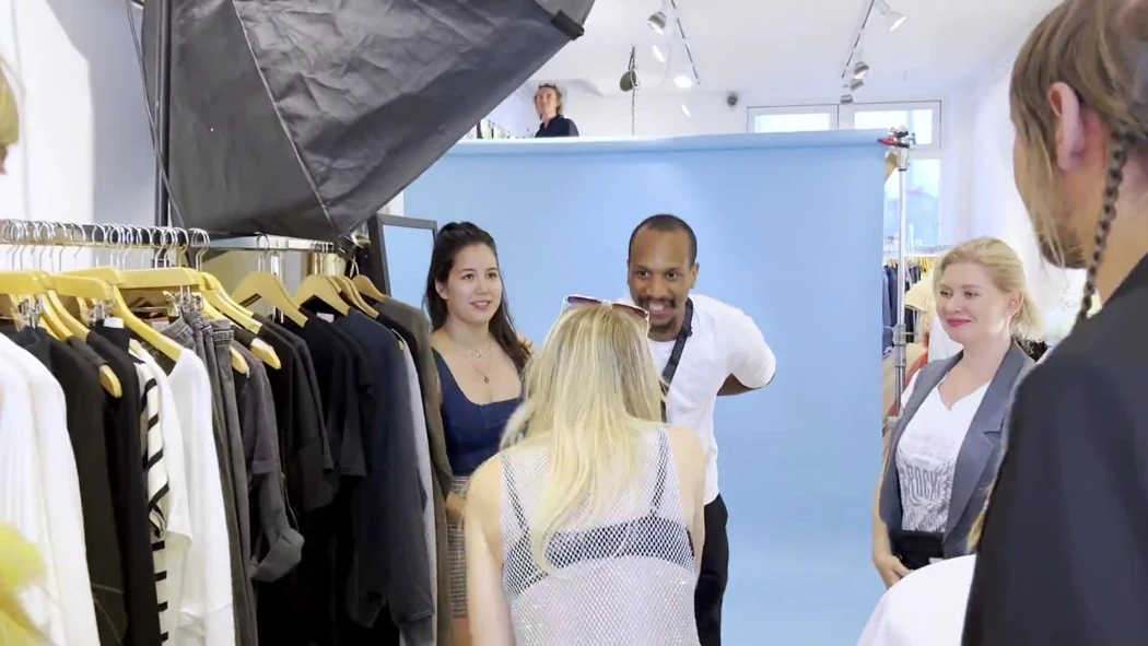 A guest being welcomed into a wardrobe studio during a previous Teleport private experience